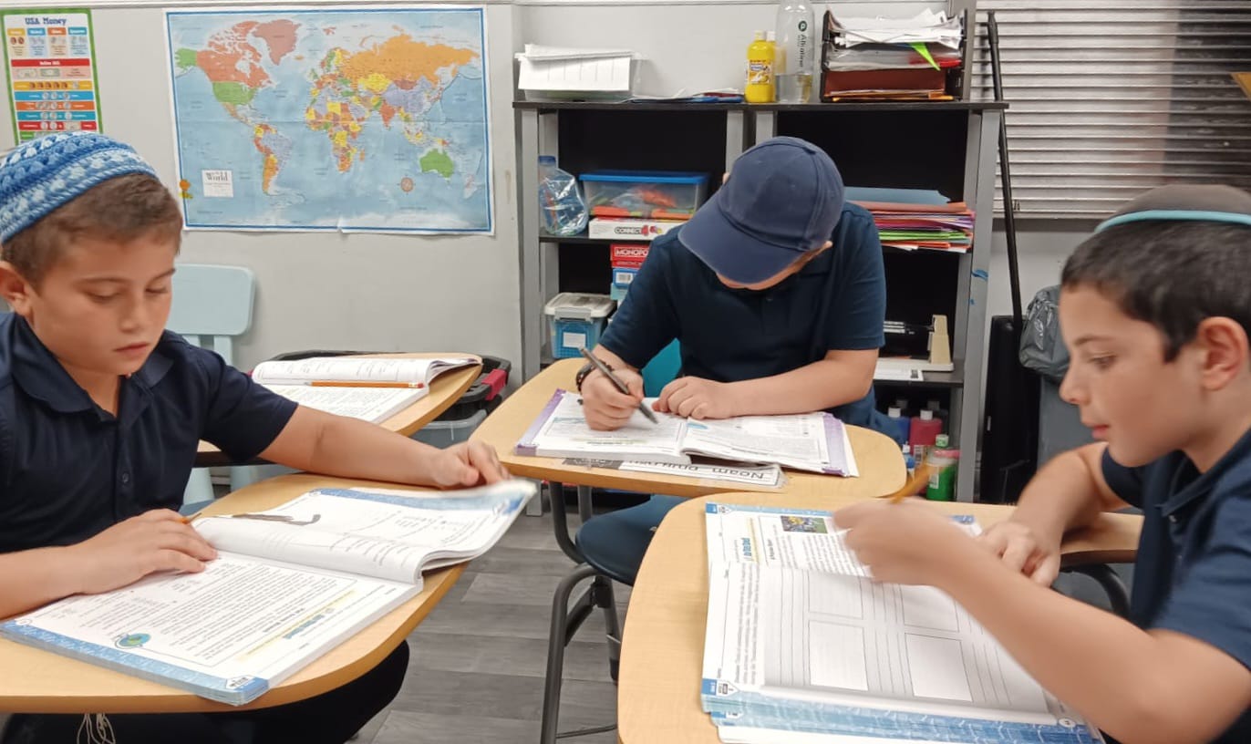 Boys studying together in a classroom